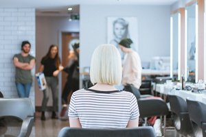 Young woman with platinum hair at the hairdresser